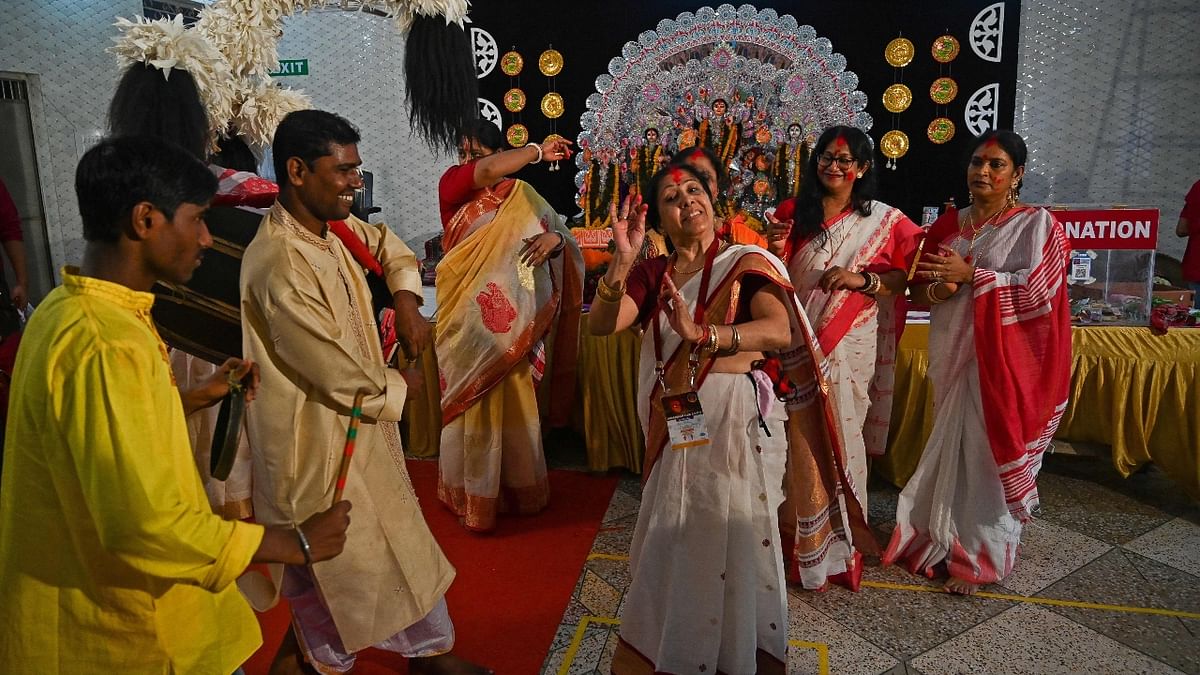 Devotees dance during the 'Sindoor Khela' as part of a traditional ritual on the last day of the Durga Puja festival in New Delhi. Credit: AFP Photo