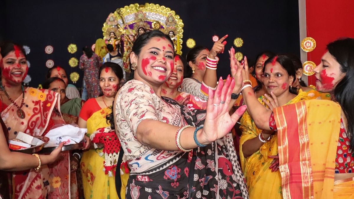 Women dance during 'sindoor khela' prior to immersion of Goddess Durga on the last day of Durga Puja, in Varanasi. Credit: PTI Photo