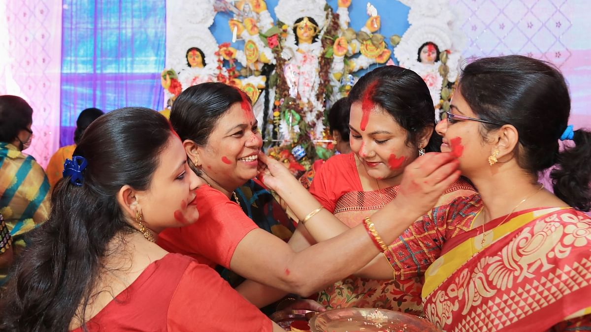 Women play with 'sindoor' on the last day of Durga Puja in Jamshedpur. Credit: PTI Photo