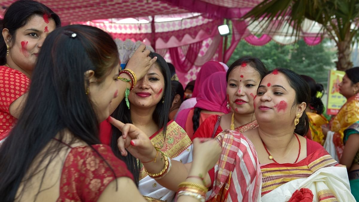 Married women play 'Sindoor Khela' before the immersion of Goddess Durga in Noida. Credit: PTI Photo