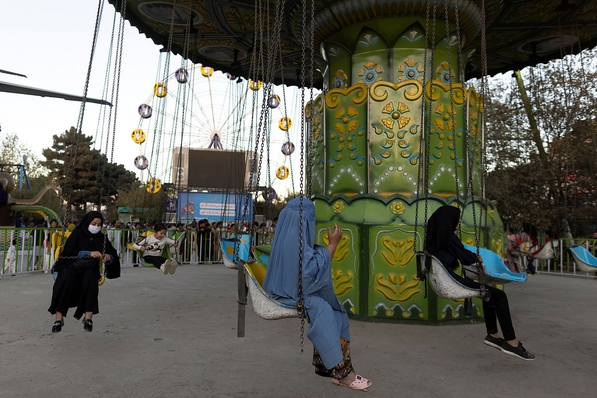A woman wearing a burqa rides an attraction at an amusement park in Kabul, Afghanistan. Credit: Reuters Photo