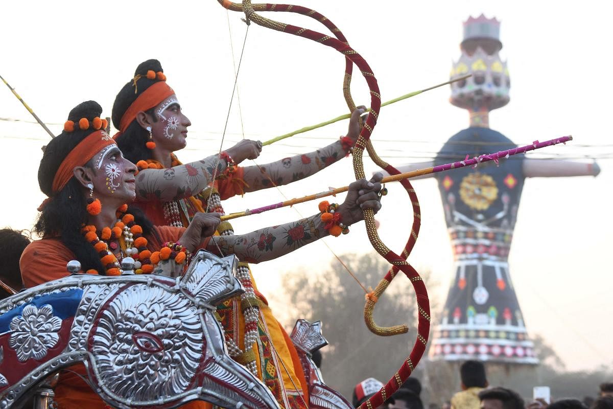 Actors dressed up as Lord Rama and Laxman aim with bows and arrows towards an effigy of Hindu demon King Ravana during Dussehra in Amritsar. Credit: AFP Photo