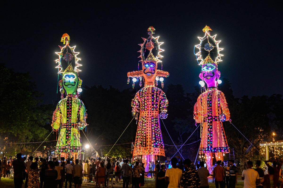 Effigies of Ravana, Meghnad, and Kumbhakarn being illuminated on the eve of Dusshera festival in Jalandhar. Credit: PTI Photo
