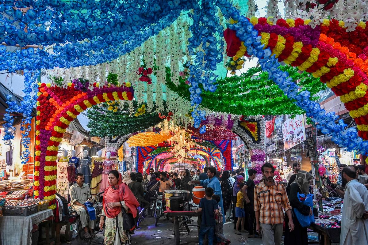 People visit a market place with floral decoration in Lahore. Credit: AFP Photo
