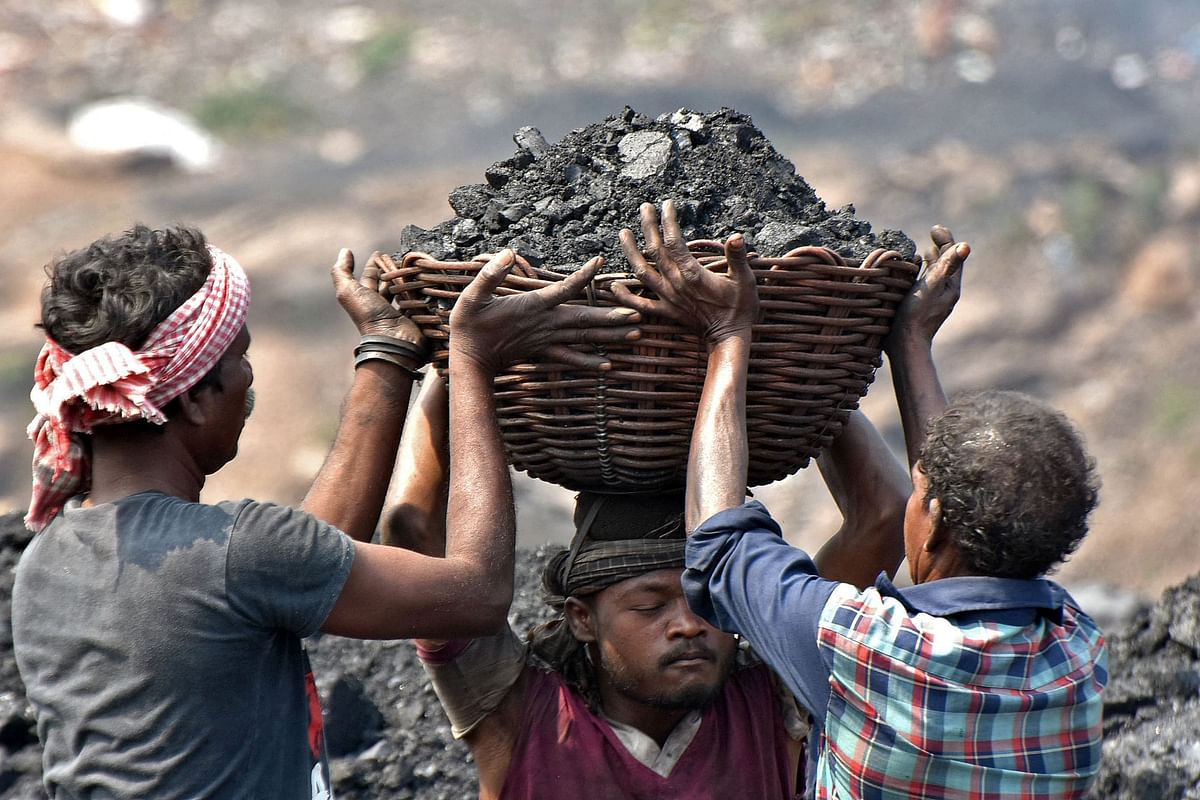 Workers prepare to load coal onto a truck at the Jharia coalfield in Dhanbad in Jharkhand. Credit: AFP Photo