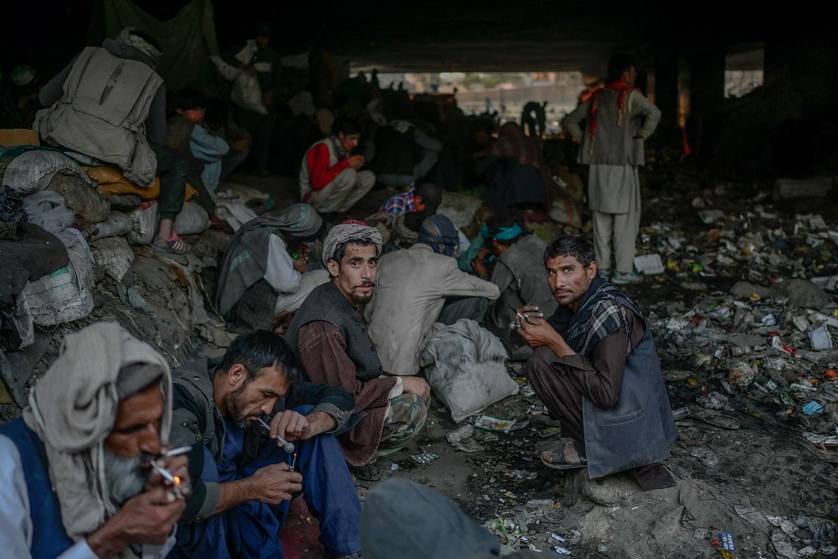 Drug users consuming drugs under a bridge where hundreds of addicted people gather in Kabul. Credit: AFP Photo