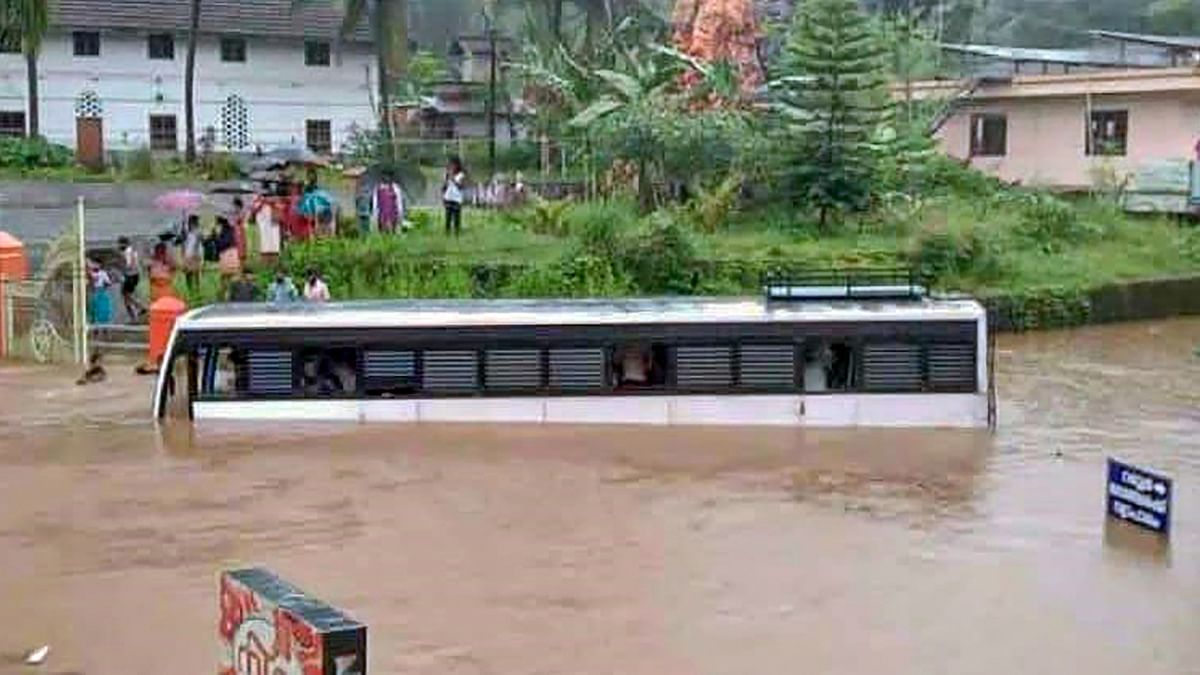 A bus partially submerged in a waterlogged area following heavy rains at Poonjaar in Kottayam. Credit: PTI Photo
