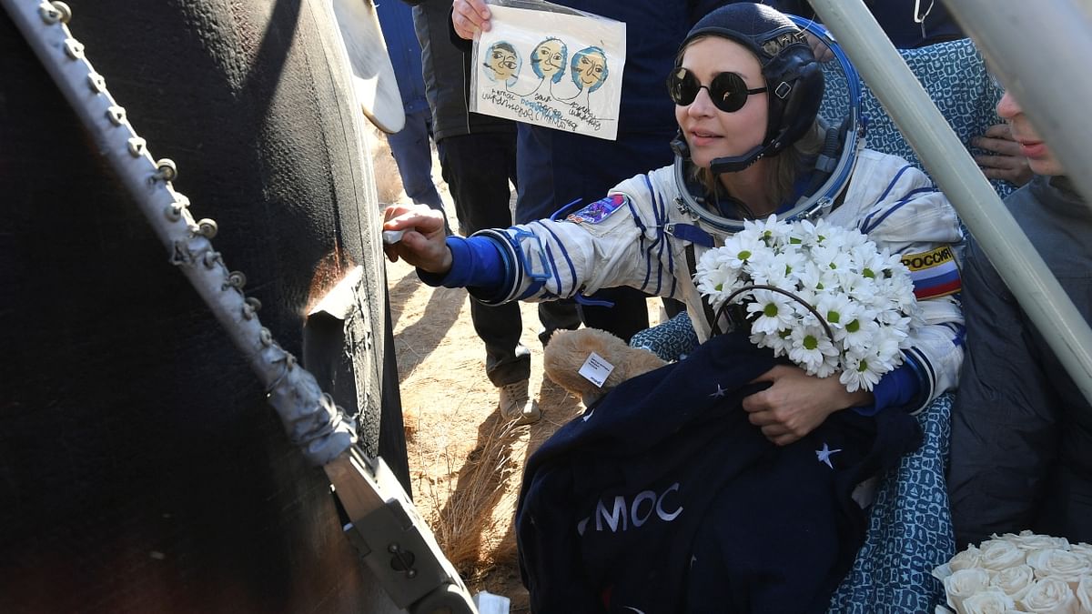 Actress Yulia Peresild signs the Soyuz MS-18 capsule after landing in Kazakhstan. Credit: Russian Space Agency Roscosmos/Reuters Photo