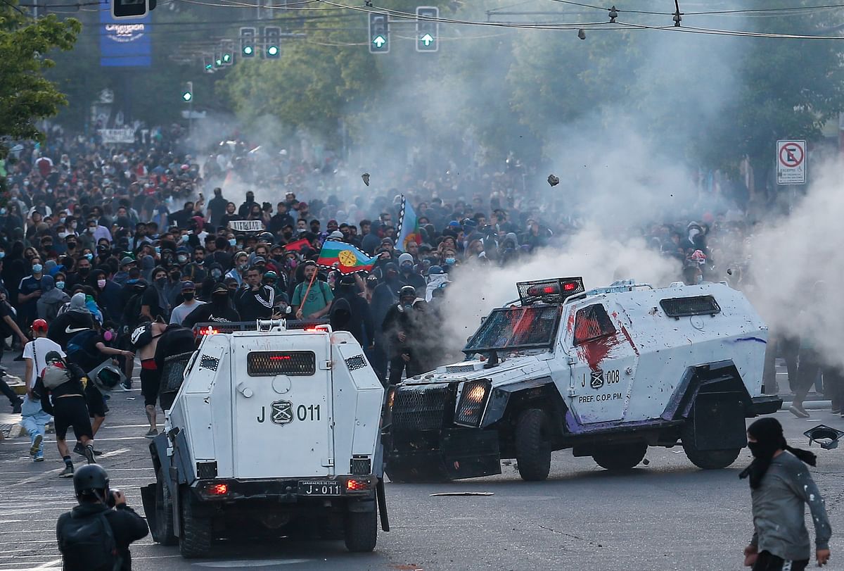 Demonstrators clash with riot police during a rally against Chile's government on the second anniversary of the protests and riots that rocked the country in 2019. Credit: Reuters Photo