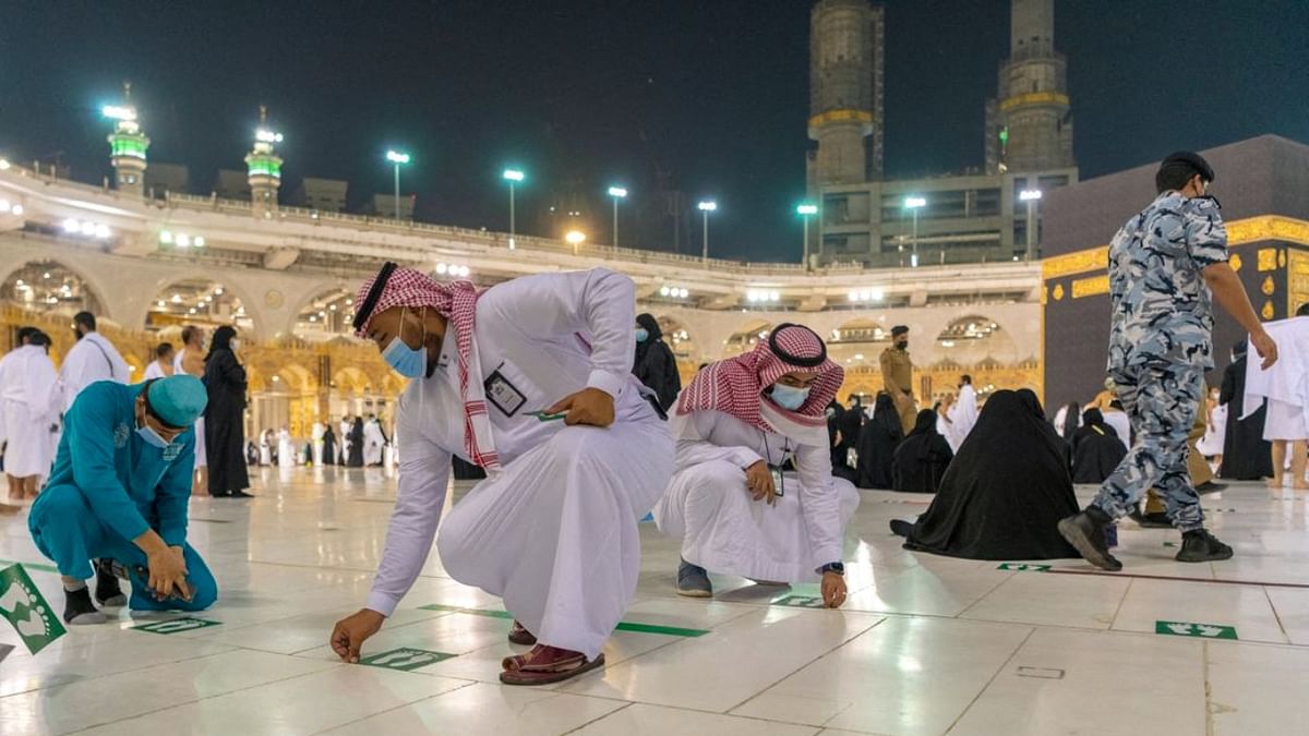 Workers removed floor markings that guide people to social distance in and around the Grand Mosque, which is built around the Kaaba, the black cubic structure towards which Muslims around the world pray. Credit: AFP Photo