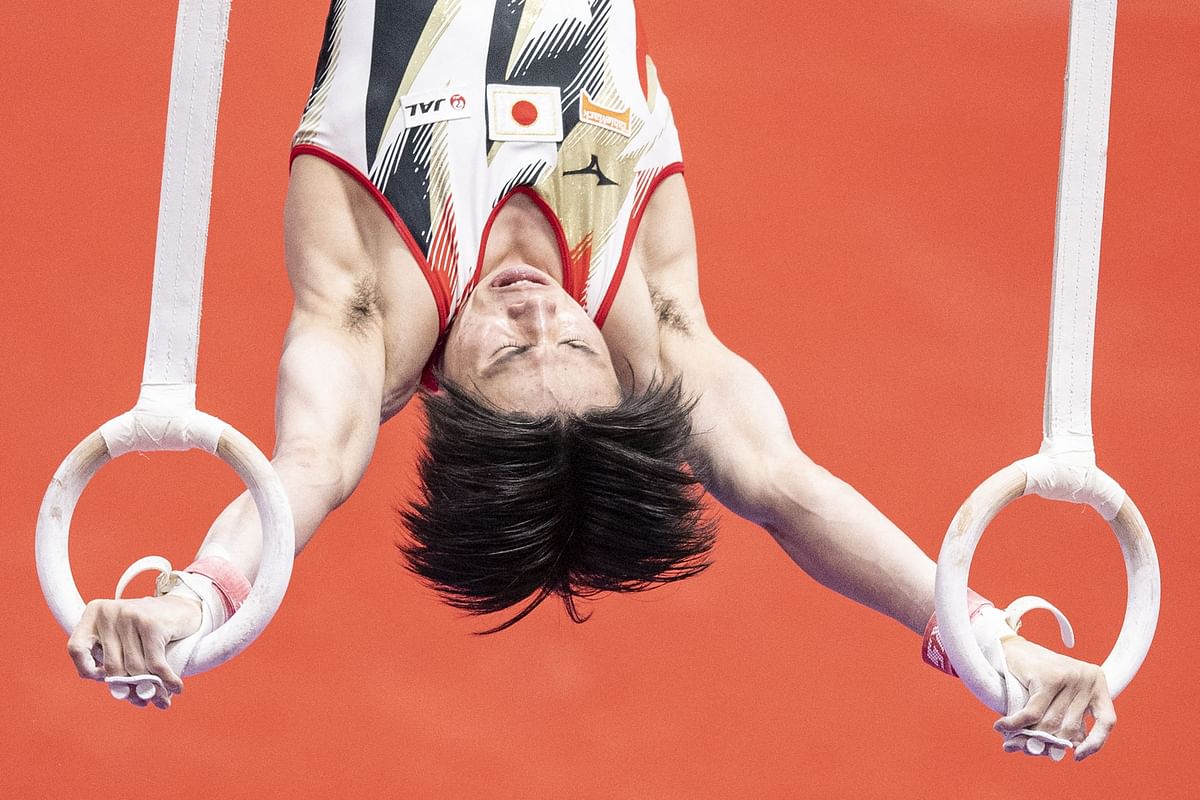 Japan's Kazuma Kaya competes in the rings event at the men’s team qualification during the Artistic Gymnastics World Championships at the Kitakyushu City Gymnasium . Credit: AFP Photo