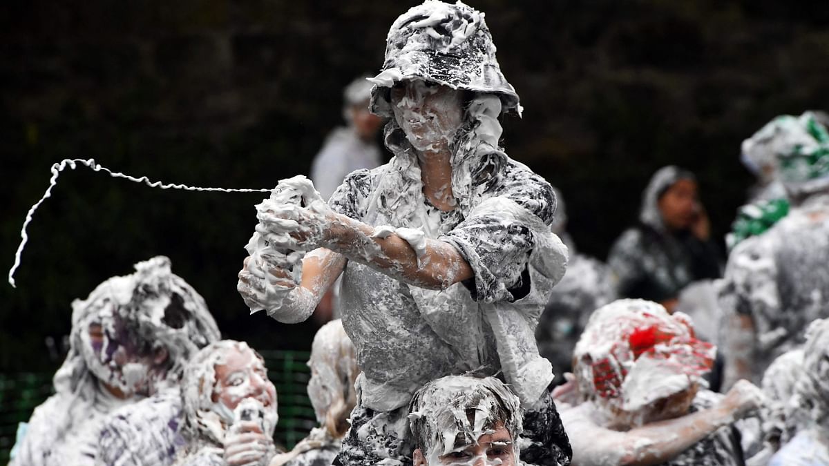 A group of freshers participate in the annual Raisin Monday shaving foam fight on the Lower College Lawn in St Andrews, Scotland. Credit: AFP Photo