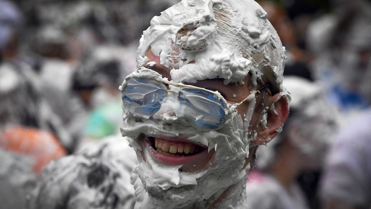 A fresher strikes a pose during the annual Raisin Monday shaving foam fight in the University of St Andrews, Scotland. Credit: AFP Photo