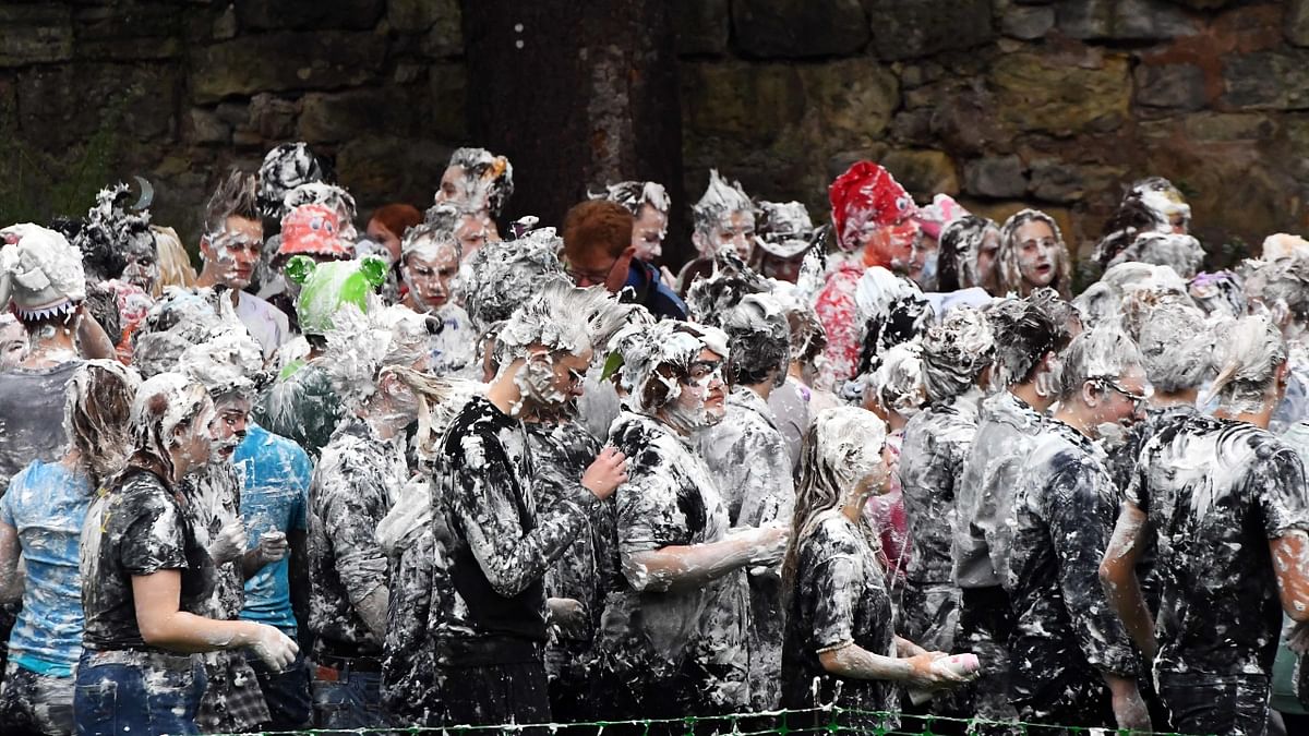 Continuing its old tradition, thousands of students put down their books and took part in a mass foam fight took at Scotland's oldest university, St Andrews. Credit: AFP Photo