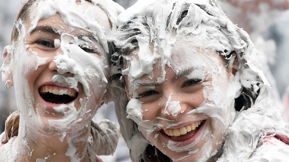 First year students pose for a photo during the annual Raisin Monday shaving foam fight in St Andrews, Scotland. Credit: AFP Photo