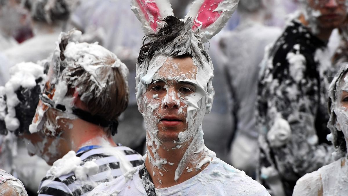 Smeared in shaving foam, a student is clicked at the Lower College Lawn in St Andrews, Scotland. Credit: AFP Photo