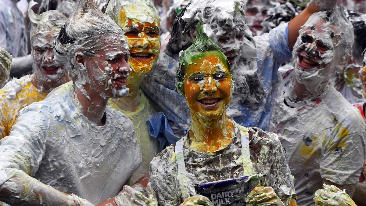 Freshers are all smiles during the annual Raisin Monday shaving foam fight in the University of St Andrews, Scotland. Credit: AFP Photo