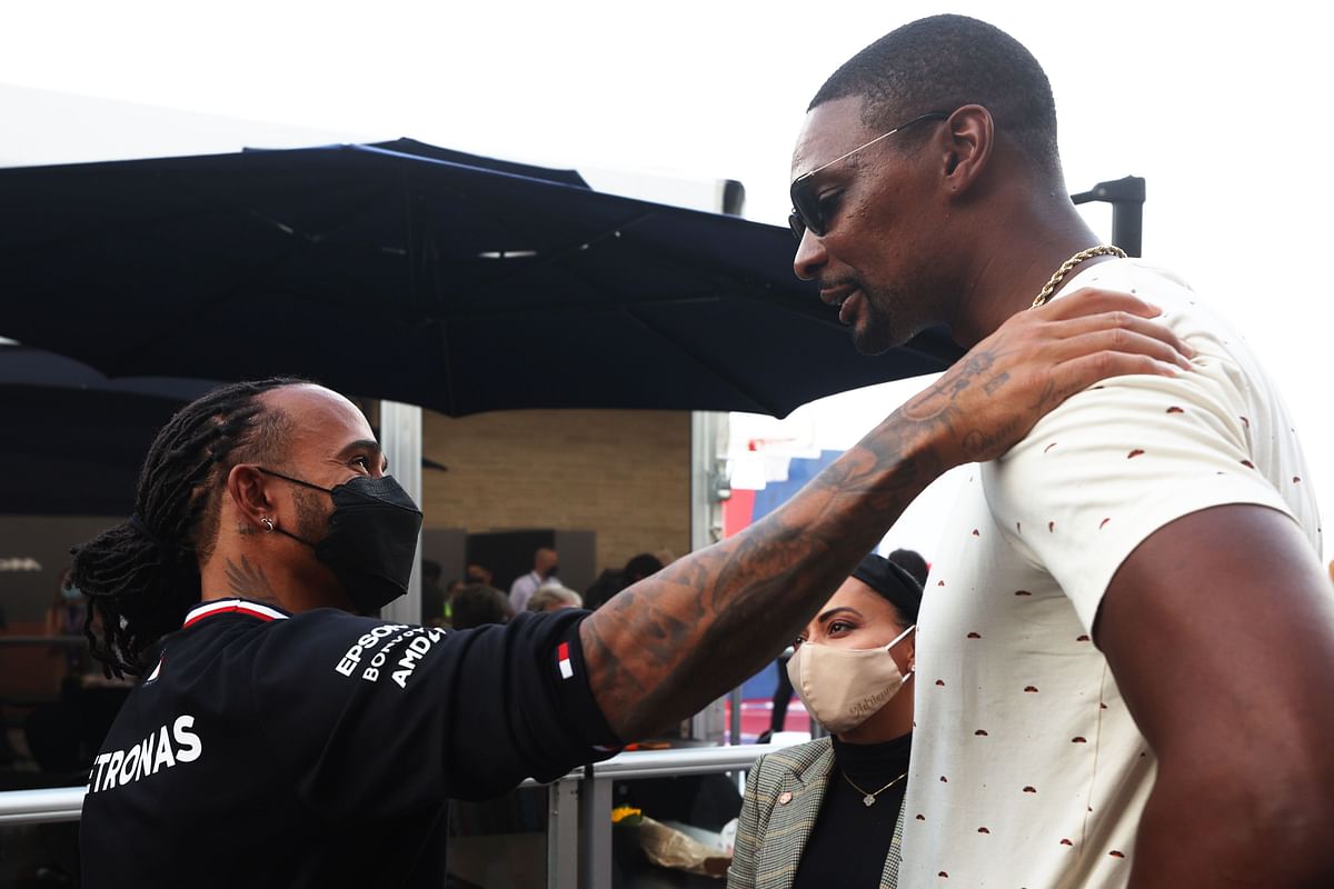 Lewis Hamilton of Great Britain and Mercedes GP talks with NBA legend Chris Bosh in the Paddock during previews ahead of the F1 Grand Prix of USA at Circuit of The Americas. Credit: AFP Photo