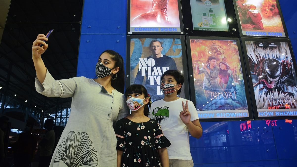 A family clicks a selfie at a cinema hall, in Thane. Credit: PTI Photo