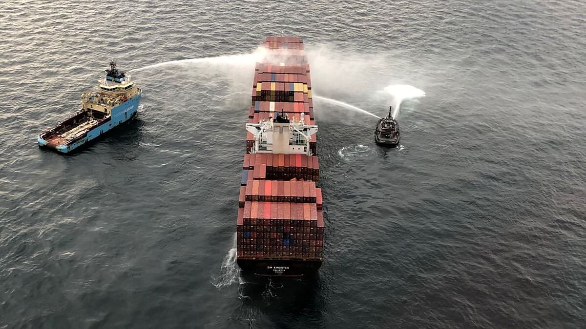 Tugboats pour water on the container ship Zim Kingston after it caught fire the day before off the coast of Victoria. Credit: Reuters Photo