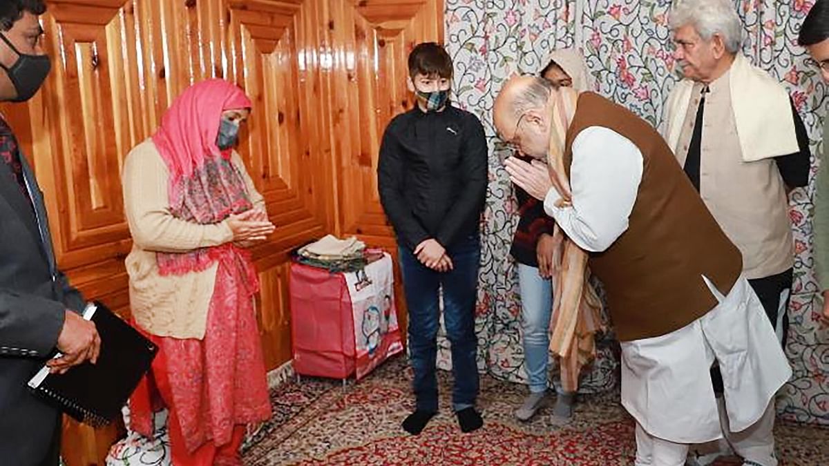 Upon landing, Amit Shah drove straight to meet the family of martyred J&K Police Inspector Parvez Ahmed, who was killed by terrorists last month. He met his wife Fatima Akhter in Nowgam and has assured her a given government job. Credit: PTI Photo