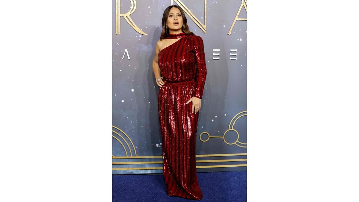 Mexican-US actor Salma Hayek wowed all in a crimson off-the-shoulder long-sleeved gown. Credit: AFP Photo