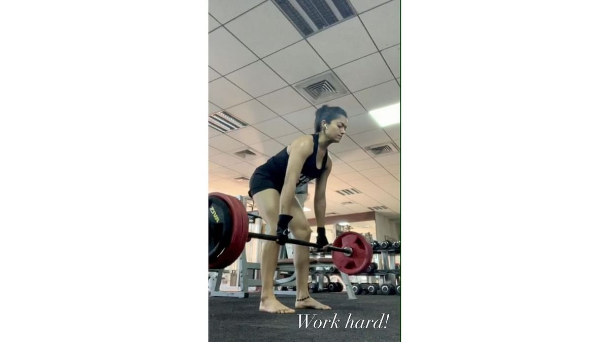 The gym-freak, Rashmika is seen lifting heavy weights in this picture. Credit: Instagram/rashmika_mandanna