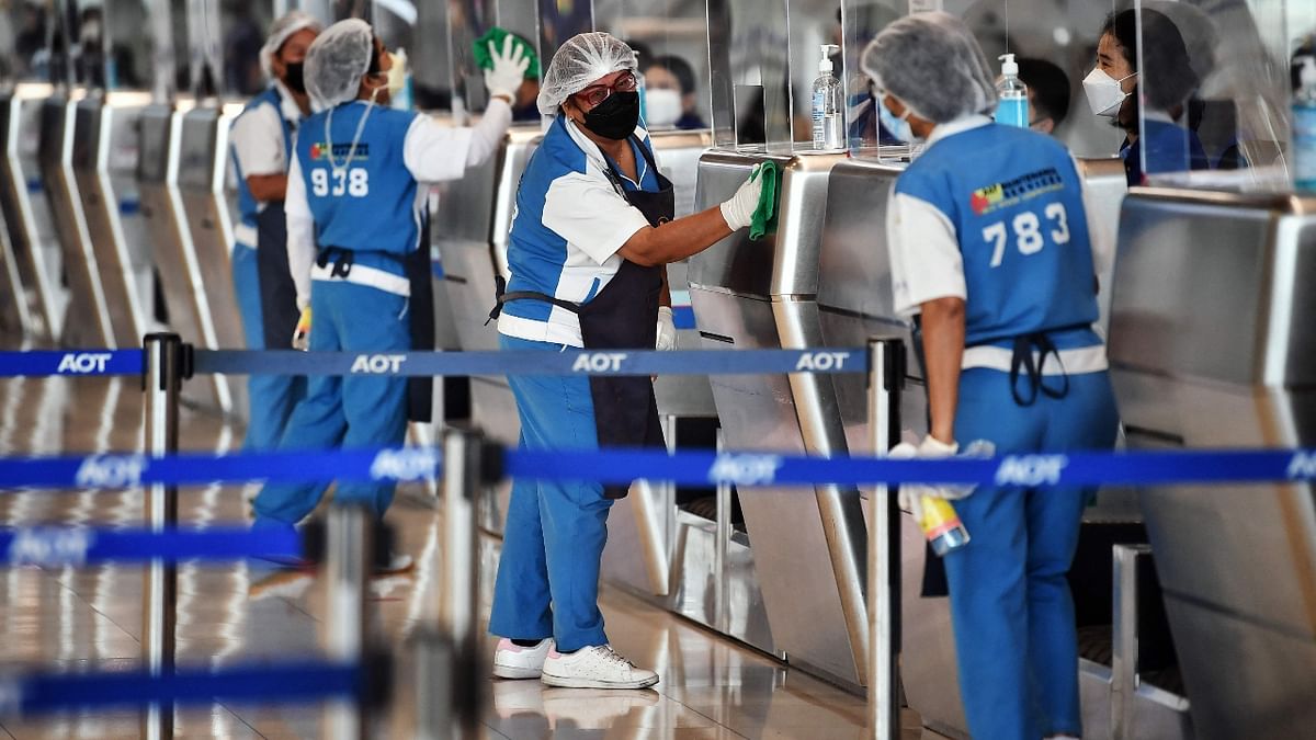 Airport staff clean the check-in kiosks at Suvarnabhumi International Airport as officials rehearse reopening procedures to welcome the first group of vaccinated tourists without quarantine on November 1, in Bangkok. Credit: AFP Photo