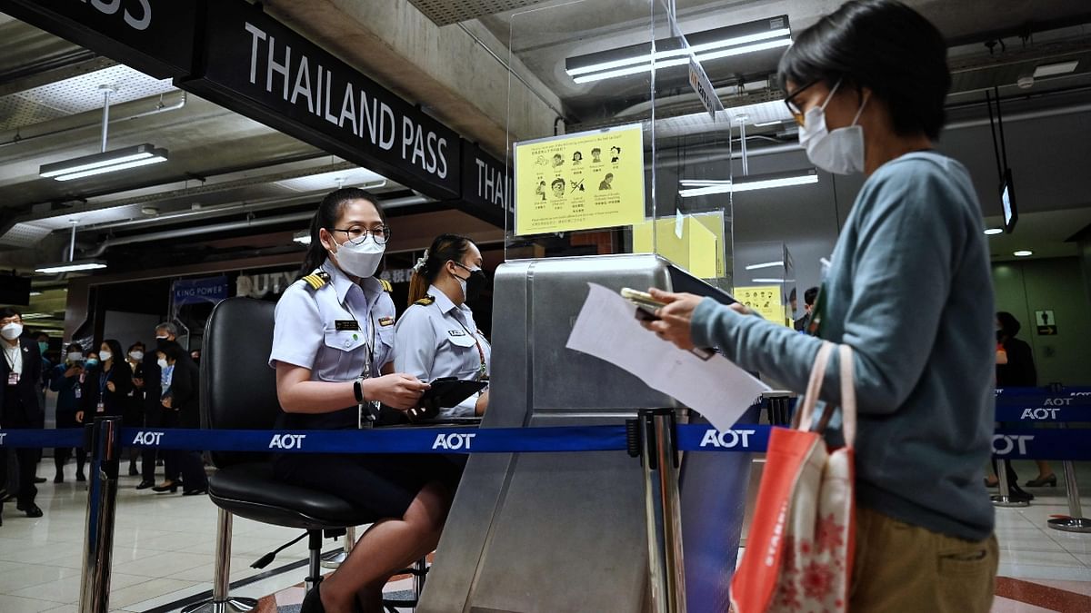 Airport staff pretend to enter Thailand at the new entry lanes at Suvarnabhumi International Airport as they rehearse reopening procedures to welcome the first group of vaccinated tourists without quarantine on November 1, in Bangkok. Credit: AFP Photo