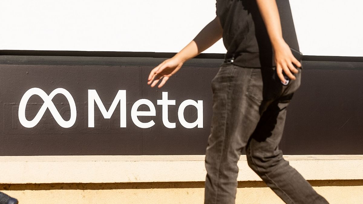 A person walks past a newly unveiled logo for