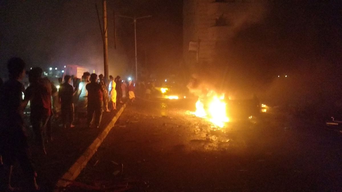 People look at cars on fire at the site of an explosion outside Aden international airport in Aden, Yemen. Credit: Reuters Photo