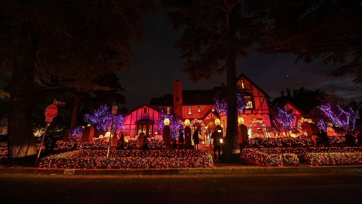 People look at a home decorated with pumpkins and ghosts for Halloween, in Burbank, California. Credit: AFP Photo