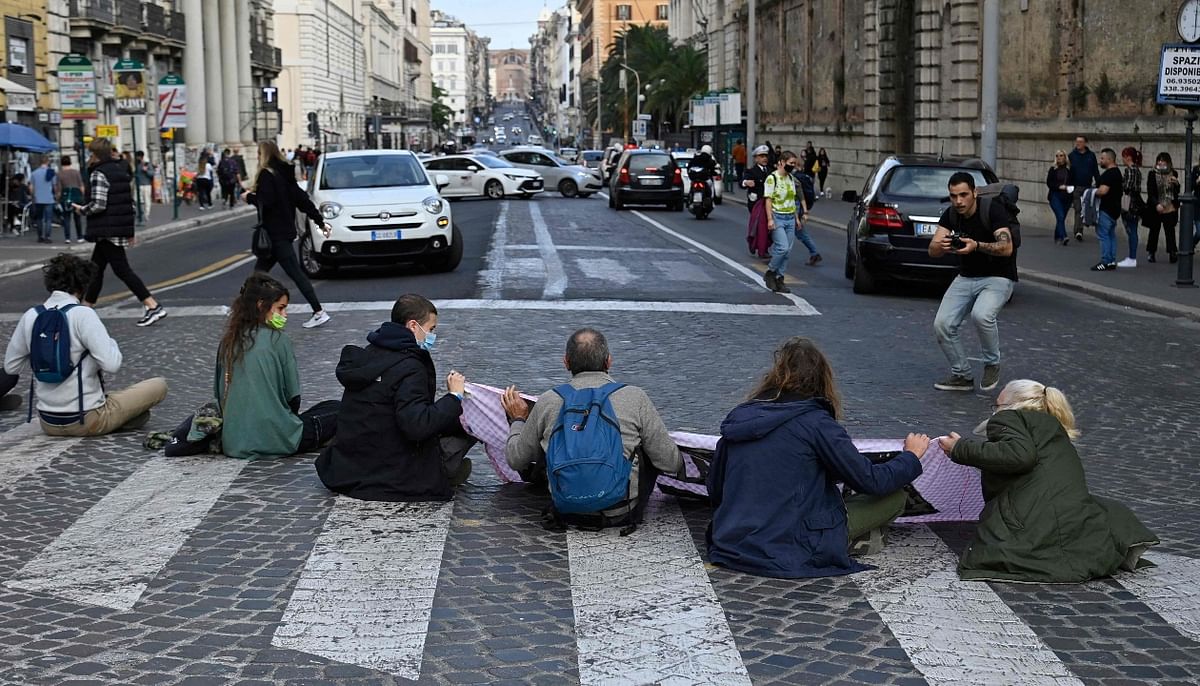 Activists from the global environmental movement Extinction Rebellion sit in the middle of Via Nazionale in central Rome while protesting against G20. Credit: AFP Photo