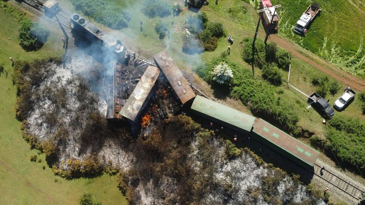 Aerial view of several freight wagons and a locomotive that were derailed and set on fire by unknown attackers in Victoria, Araucania region, Chile. Credit: AFP Photo