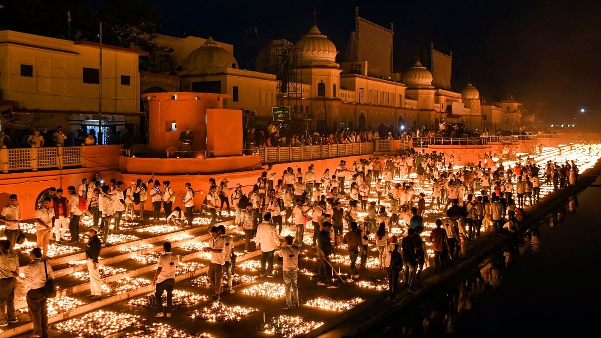 Hundreds of volunteers light earthen lamps at Ram Ki Pauri on the occasion of Deepotsav festival, in Ayodhya. Credit: PTI Photo