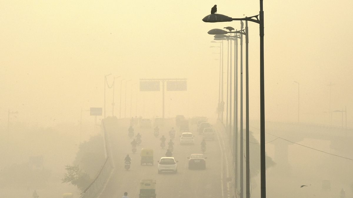 Vehicles ply amid low visibility due to a thick layer of smog, a day after Diwali celebrations in New Delhi. Credit: PTI Photo