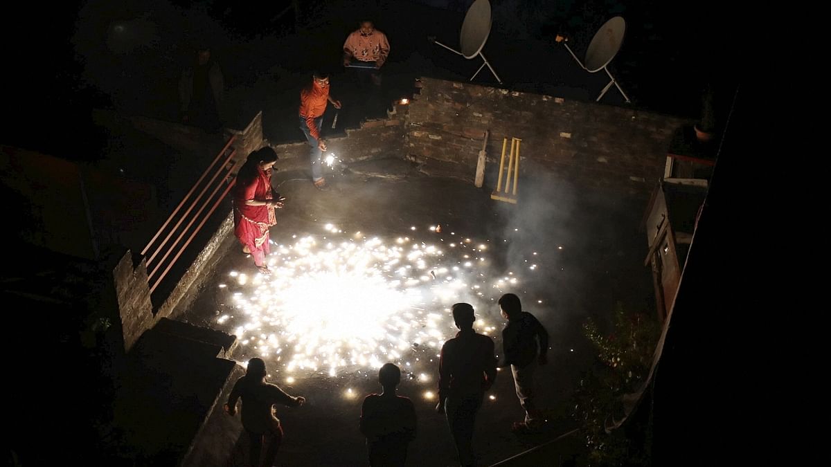 People burn firecrackers to celebrate the festival of lights in Jammu. Credit: PTI Photo