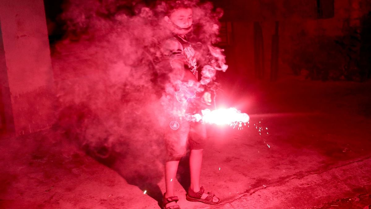 A boy lights fireworks to celebrate Diwali in Kolkata. Credit: Reuters Photo