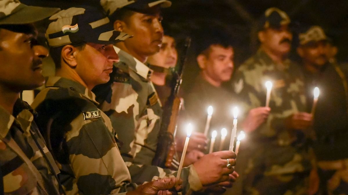Border Security Force (BSF) personnel celebrate Diwali near the Indo-Bangladesh Border fence at Dangee in South Dinajpur district of West Bengal. Credit: PTI Photo