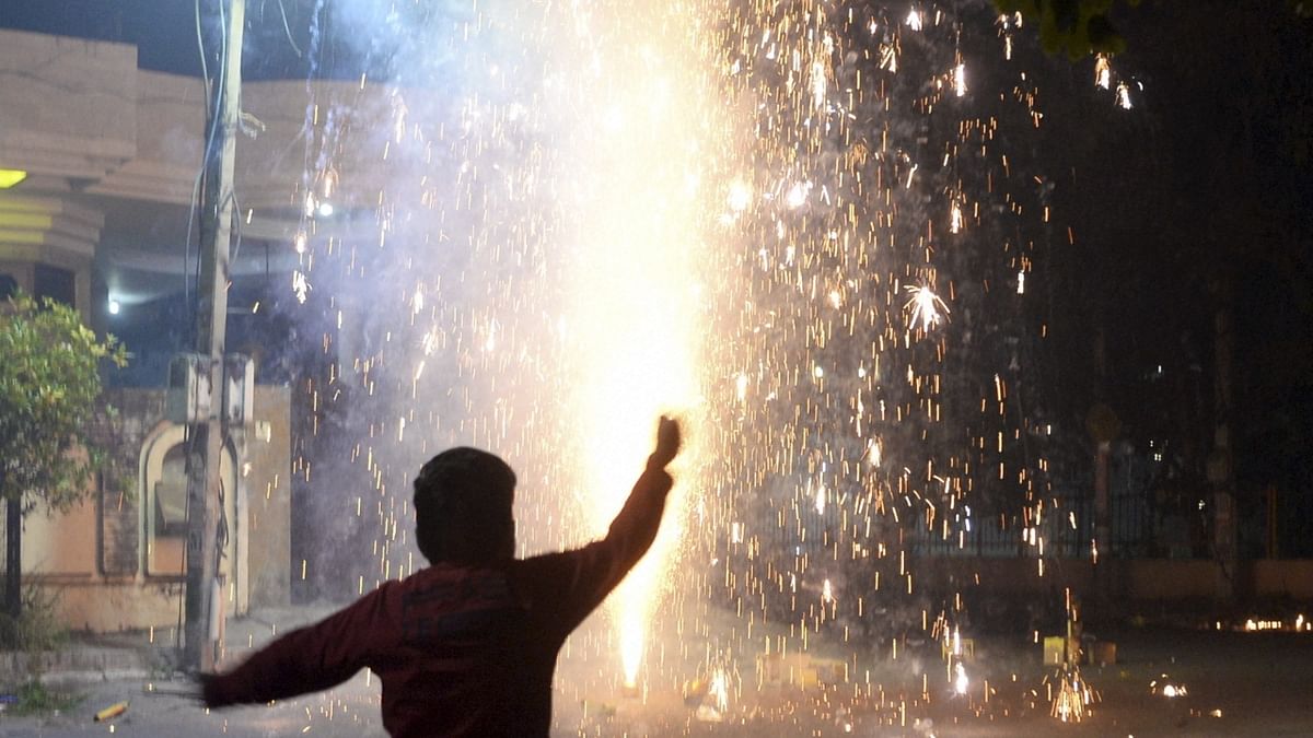 A boy reacts as he burns firecrackers during Diwali festival in Jalandhar, Punjab. Credit: PTI Photo