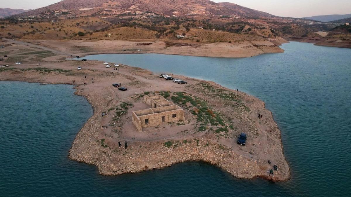 An aerial view shows the remains of the submerged Gary Qasruka village abandoned 36 years ago, which have resurfaced following a large drop in water level of the Dohuk Dam due to drought, in the northern Iraqi city of Dohuk in the autonomous Kurdish region. Credit: AFP Photo