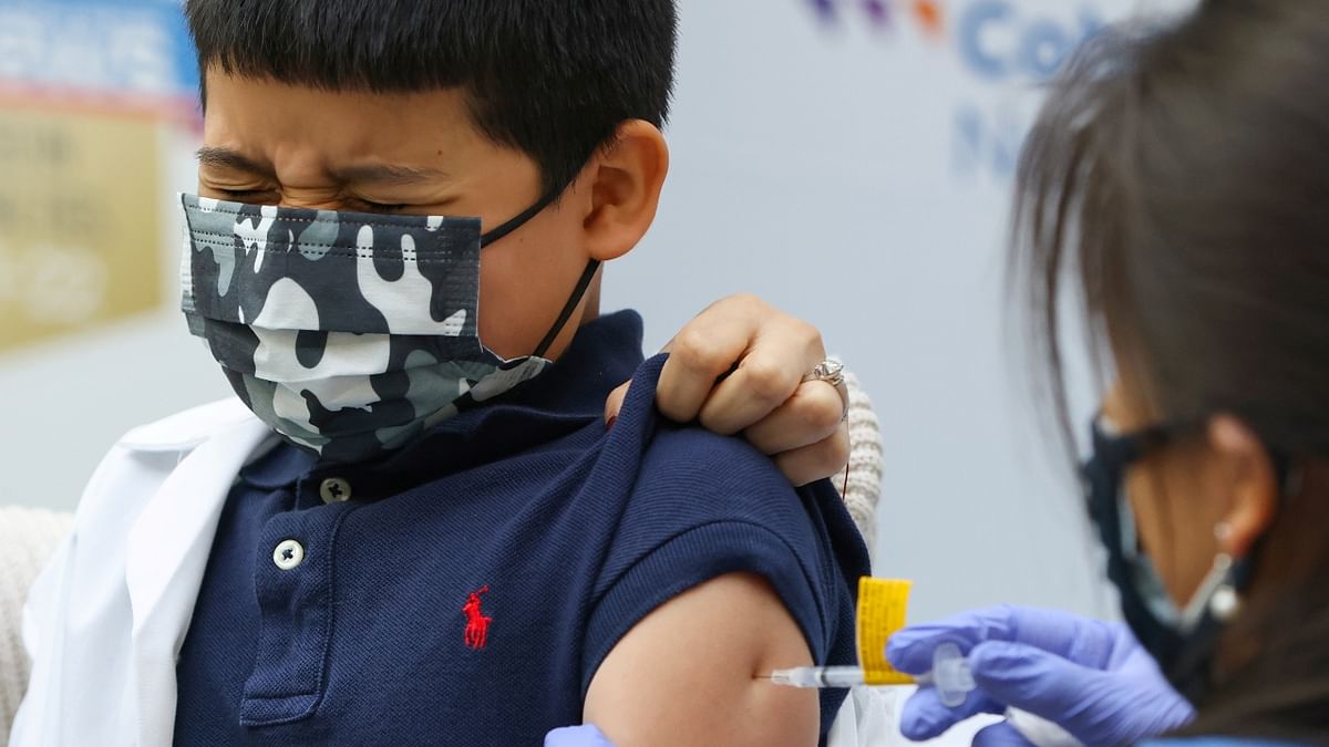A young boy reacts as he receives the Pfizer-BioNTech Covid-19 vaccine at Cohen Children's Medical Center in New Hyde Park, New York. Credit: Reuters Photo