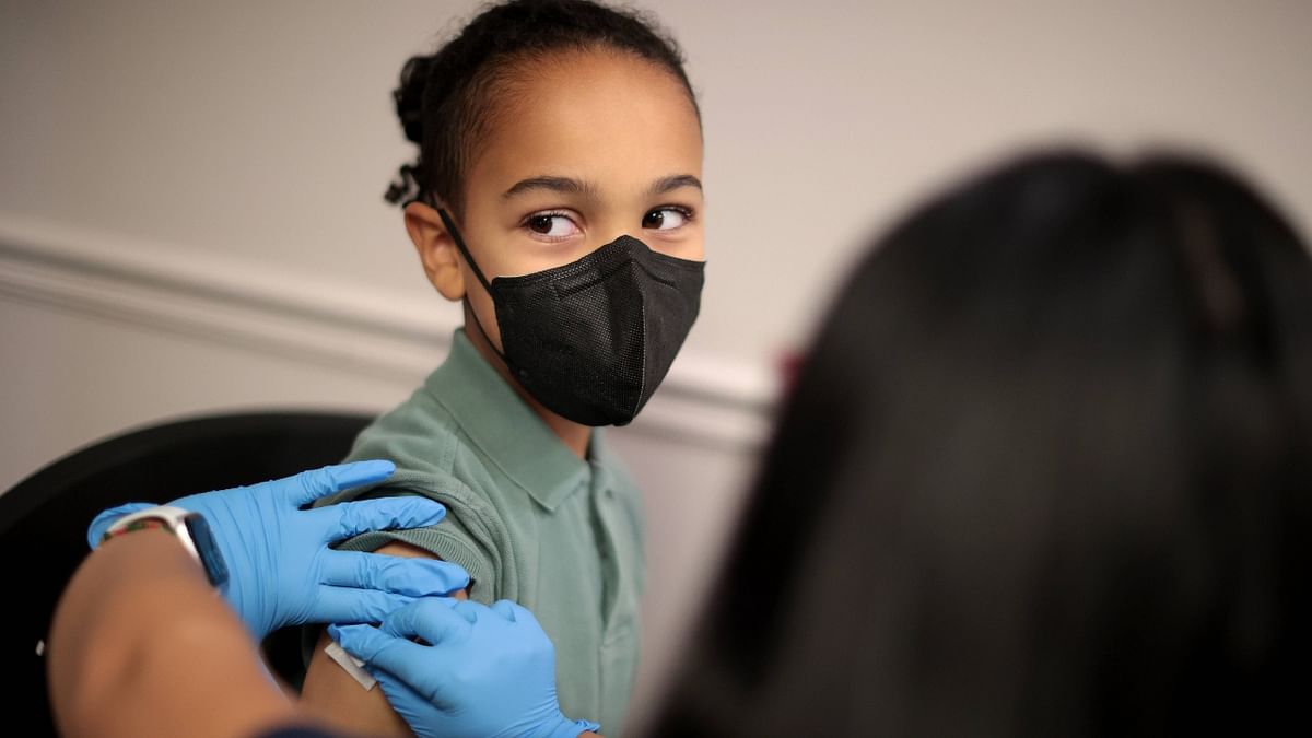 A child receives the Pfizer BioNTech Covid-19 vaccination at the Fairfax County Government Center in US. Credit: AFP Photo