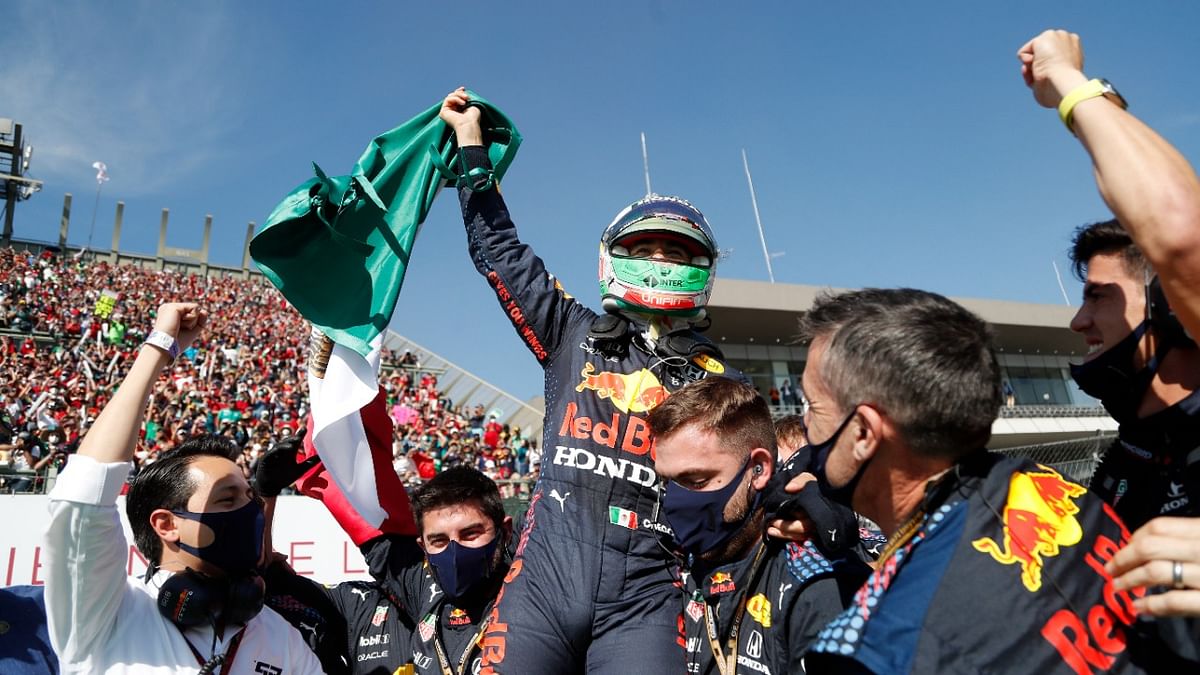 Red Bull's Sergio Perez celebrates with his team after finishing third in his home race in Mexico City. Credit: Reuters Photo
