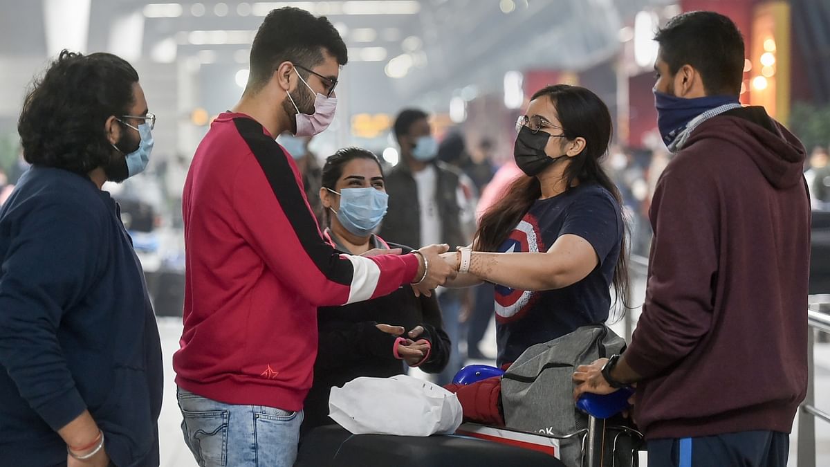 A passenger bids an emotional goodbye to her family at the Terminal 3 of the IGI Airport in New Delhi. Credit: PTI Photo