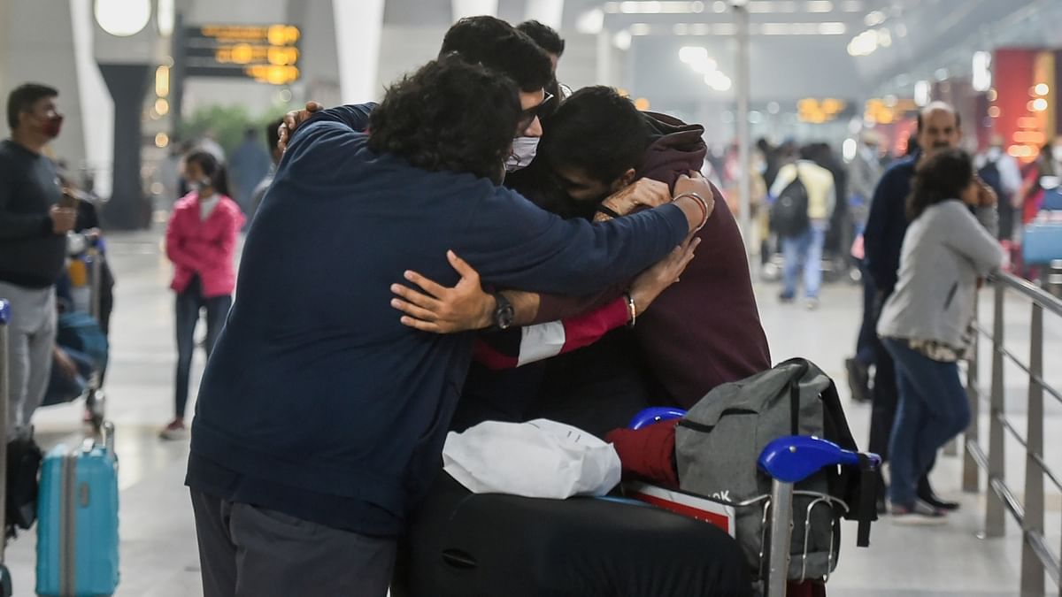 A passenger bids an emotional goodbye to family before boarding a flight in New Delhi. Flight services to the US resumed for the fully vaccinated passengers from November 8. Credit: PTI Photo