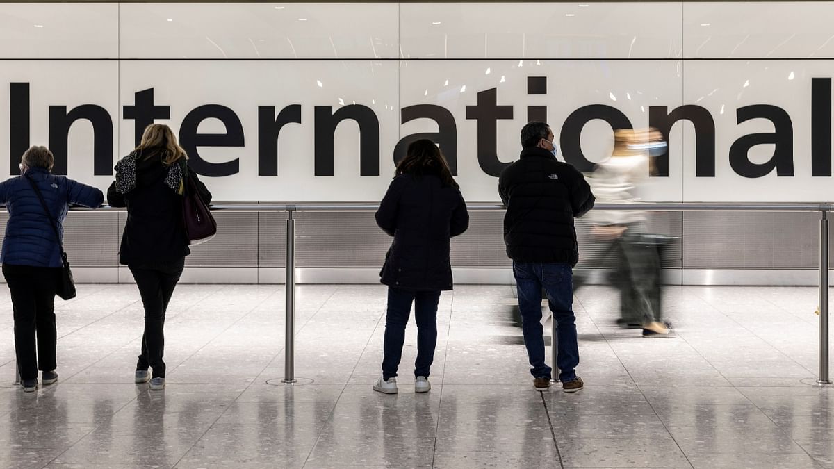 People are seen waiting at the arrivals area of terminal 5 at Heathrow International airport during the first day after the lifting on travel restrictions. Credit: Reuters Photo