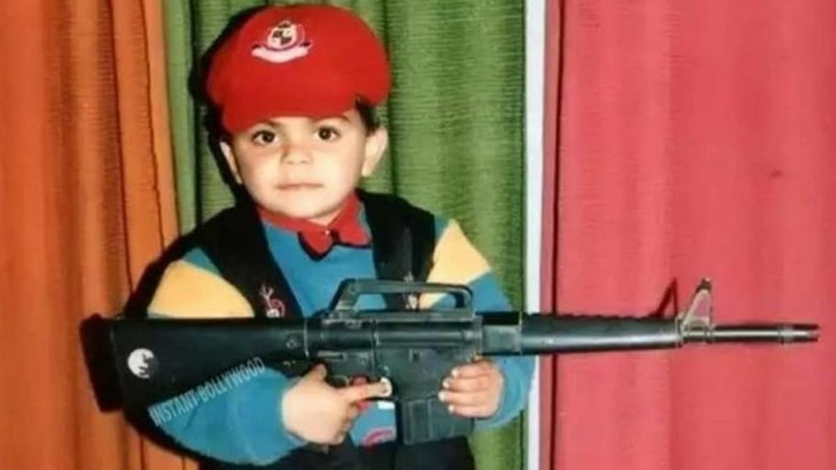 Childhood picture of Kohli shows him posing with a toy gun. Credit: Instagram/virat.kohli.forever___