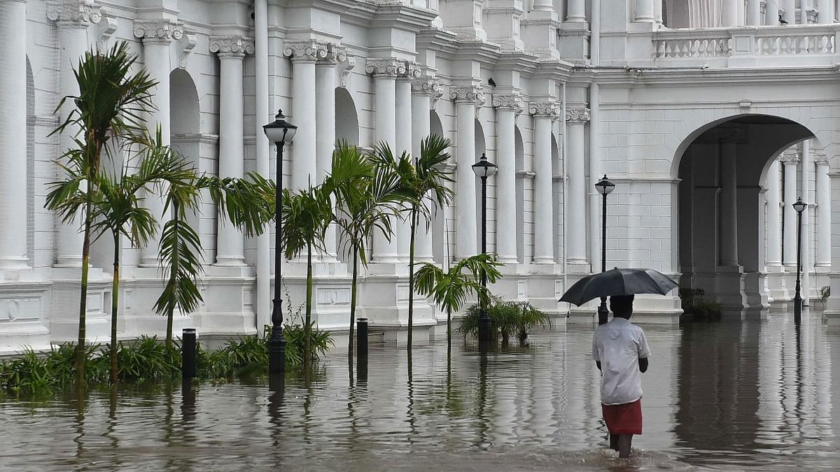A man walks through the flooded complex of Ripon Building in Chennai. Credit: AFP Photo
