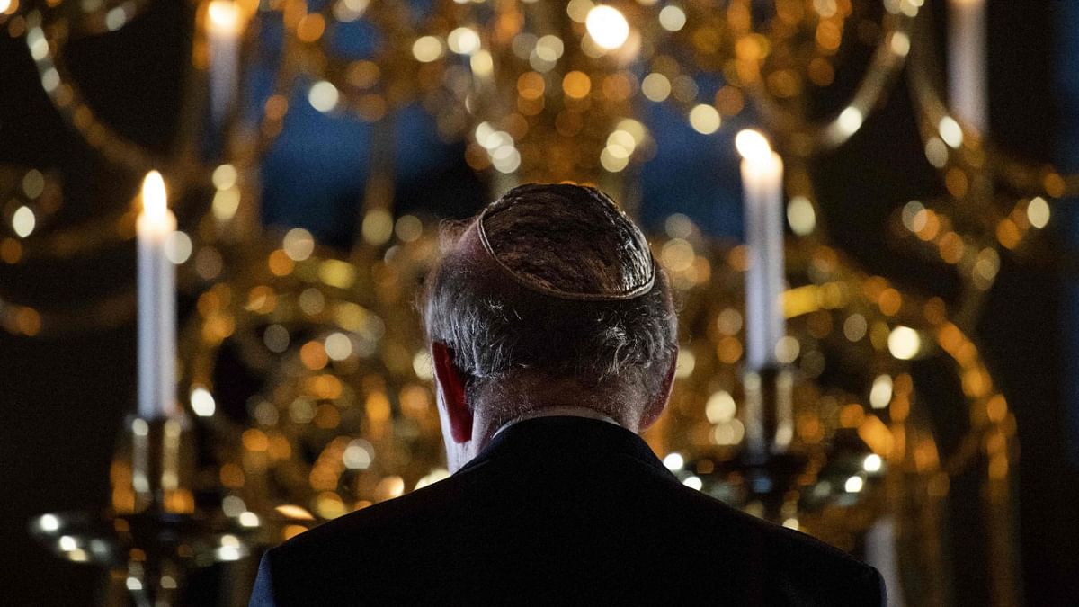 Chairman of the Central Jewish Consultation, Ronny Naftaniel, hosts the annual national commemoration of the Kristallnacht (Night of Broken Glasses) in the Portuguese-Israeli Synagogue in Amsterdam. Credit: AFP Photo